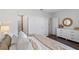 Bedroom featuring a white dresser with round mirror and modern decor at 2060 Monteverde Ave, Davenport, FL 33837