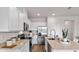 Modern kitchen boasting sleek white cabinets, stainless steel appliances, and a central island at 2060 Monteverde Ave, Davenport, FL 33837