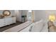 Light-filled bedroom with white dresser, round mirror, and view to closet at 2064 Monteverde Ave, Davenport, FL 33837