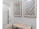 Hallway with neutral decor, modern wall art, and woven bench at 2064 Monteverde Ave, Davenport, FL 33837