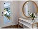 Inviting entryway with modern decor, console table, mirror, and views of the front yard at 2068 Monteverde Ave, Davenport, FL 33837