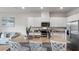 Well-lit kitchen with stainless steel appliances, a large island, and open to the living area at 2068 Monteverde Ave, Davenport, FL 33837