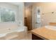 Bathroom with tub and shower featuring natural light and updated fixtures at 2320 Red Ember Rd, Oviedo, FL 32765