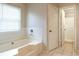Bright bathroom featuring a built-in tub and a separate shower, offering a serene and functional space at 2320 Red Ember Rd, Oviedo, FL 32765