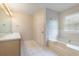Well-lit bathroom featuring a bathtub, vanity, and tiled floor at 2320 Red Ember Rd, Oviedo, FL 32765