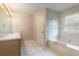 Bathroom featuring a soaking tub, single sink vanity, and tile flooring at 2320 Red Ember Rd, Oviedo, FL 32765