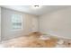 Empty bedroom featuring a window with blinds and door with bare flooring at 2320 Red Ember Rd, Oviedo, FL 32765