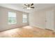 Bedroom with a ceiling fan and two windows featuring bare flooring and a white door at 2320 Red Ember Rd, Oviedo, FL 32765