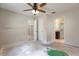 Large bedroom featuring a ceiling fan and multiple doorways, offering versatility and potential at 2320 Red Ember Rd, Oviedo, FL 32765