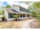 Beautiful two-story home with a large front porch, surrounded by lush greenery and mature trees at 2320 Red Ember Rd, Oviedo, FL 32765