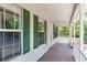 Inviting front porch of a charming home featuring green shutters and ample natural light at 2320 Red Ember Rd, Oviedo, FL 32765