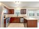 Well-lit kitchen featuring stainless steel appliances, tile floors, and abundant counter space at 2320 Red Ember Rd, Oviedo, FL 32765