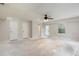Large living room with ceiling fan, multiple doorways, and one window. Bare floor at 2320 Red Ember Rd, Oviedo, FL 32765