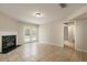Bright living room with tile floors, fireplace with green accents, and french doors to the yard at 2320 Red Ember Rd, Oviedo, FL 32765