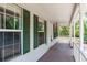 View of the front porch featuring green shutters and a view of the surrounding yard and foliage at 2320 Red Ember Rd, Oviedo, FL 32765