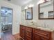 Bathroom with a double sink granite vanity and a view of the bedroom at 2350 Worthington Rd, Maitland, FL 32751