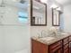 Bright bathroom with a double sink granite vanity and a tiled shower at 2350 Worthington Rd, Maitland, FL 32751