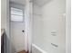 Bright bathroom featuring a white shower and bathtub combo, with a frosted glass window at 2350 Worthington Rd, Maitland, FL 32751