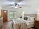Bedroom featuring hardwood floors and large windows to view the outside foliage at 2350 Worthington Rd, Maitland, FL 32751