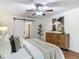 Bedroom featuring modern ceiling fan, sliding door to the bathroom, and stylish accents at 2350 Worthington Rd, Maitland, FL 32751