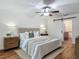 Bedroom with hardwood floors, a ceiling fan, and a decorative sliding door for the bathroom at 2350 Worthington Rd, Maitland, FL 32751