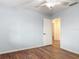 Bedroom with wood floors and a doorway leading to another room, and ceiling fan at 2350 Worthington Rd, Maitland, FL 32751