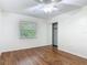 Bedroom showcasing wood-look floors, closet, window, and a ceiling fan at 2350 Worthington Rd, Maitland, FL 32751