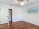 Bedroom featuring a ceiling fan, closet, a window, and wood-look floors at 2350 Worthington Rd, Maitland, FL 32751