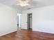 Bedroom with wood-look flooring, closet, a ceiling fan, and access to another room at 2350 Worthington Rd, Maitland, FL 32751