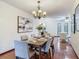 Dining room with decorative chandelier, seating for six, and tile flooring at 2350 Worthington Rd, Maitland, FL 32751