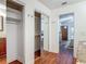 Hallway with closets and a mirrored sliding door between bathroom and bedroom at 2350 Worthington Rd, Maitland, FL 32751