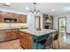 Kitchen featuring a central island with granite countertop and a brick fireplace at 2350 Worthington Rd, Maitland, FL 32751