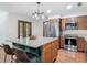 Bright kitchen with granite countertops, stainless steel appliances, island with seating, and wooden cabinets at 2350 Worthington Rd, Maitland, FL 32751