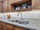 Close-up of kitchen granite countertops and stainless-steel sink with wooden cabinets at 2350 Worthington Rd, Maitland, FL 32751
