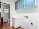 Laundry room features white cabinets, neutral paint, and tile floors at 2350 Worthington Rd, Maitland, FL 32751