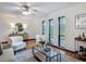 Bright living room featuring tile floors, a ceiling fan, and large windows offering great natural light at 2350 Worthington Rd, Maitland, FL 32751