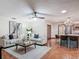 Spacious living room open to kitchen featuring comfortable seating and stylish decor with tile flooring at 2350 Worthington Rd, Maitland, FL 32751