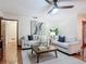 Cozy living room with neutral sofas, stylish decor, and terra cotta flooring throughout at 2350 Worthington Rd, Maitland, FL 32751