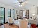 Open concept living room with neutral colors, an area rug, and views of the landscaped backyard at 2350 Worthington Rd, Maitland, FL 32751