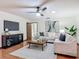 Comfortable living room featuring tile floors, a ceiling fan, and two couches at 2350 Worthington Rd, Maitland, FL 32751