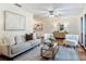 Cozy living room with plush seating, a ceiling fan, and a modern coffee table atop an area rug at 2350 Worthington Rd, Maitland, FL 32751