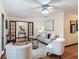Spacious living room featuring two comfortable chairs, neutral tones, and terracotta tiled flooring at 2350 Worthington Rd, Maitland, FL 32751