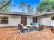 Outdoor patio with a cozy seating area, brick flooring, and an outdoor lounging area at 2350 Worthington Rd, Maitland, FL 32751