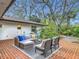 Brick paved patio area with a lounge set and green landscaping surrounding the outdoor space at 2350 Worthington Rd, Maitland, FL 32751