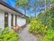 Exterior landscape along the side of the home including a wooden bench at 2350 Worthington Rd, Maitland, FL 32751