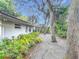 Lush landscaping and trees adorn the side yard with pea gravel at 2350 Worthington Rd, Maitland, FL 32751