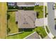 Aerial view of a house featuring a well-maintained roof, a neatly paved driveway, and a green lawn at 2431 Knoll Dr, Apopka, FL 32712