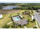 This aerial view showcases a pool, clubhouse, and playground by the lake in a beautiful community at 2431 Knoll Dr, Apopka, FL 32712