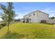 Spacious backyard featuring a well-maintained lawn and patio area with a view of the home's exterior at 2431 Knoll Dr, Apopka, FL 32712