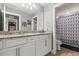 Well-lit bathroom features double vanity, granite countertops and a shower at 2431 Knoll Dr, Apopka, FL 32712